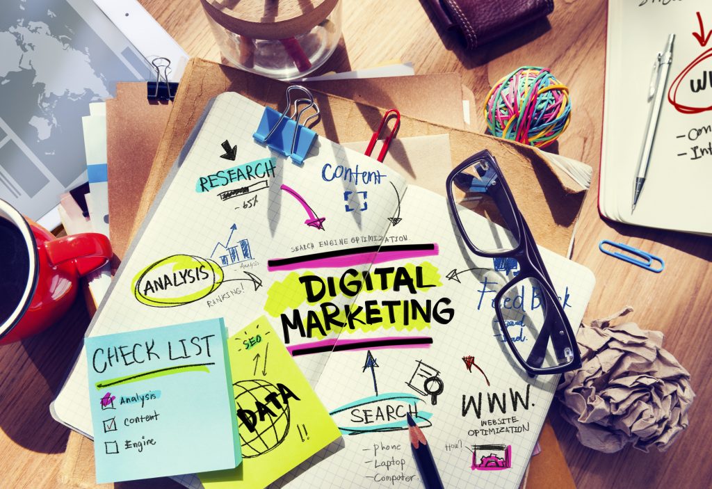 Office Desk with Tools and Notes About Digital Marketing